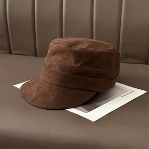 Close-up of pleated brown suede flat-top cadet cap with soft texture