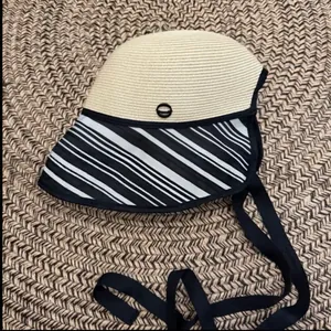 Detailed view of women's sun bucket hat with striped brim and elegant black ribbon tie