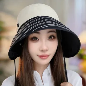 Stylish wide brim sun hat for women with adjustable ribbon tie and striped detail