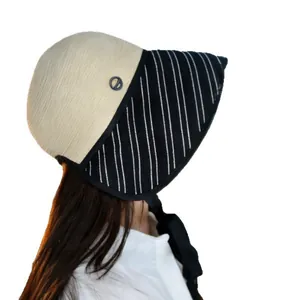 Elegant women's summer sun protection bucket hat with striped brim and black ribbon tie