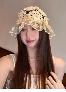 Detail view of handmade crochet flower hat with elegant lace brim for summer