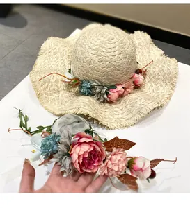 Close-up of handmade raffia sun hat with decorative floral wreath accessory