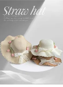 Detailed shot of straw sun hats with lace bows and tulip flower accents in several shades