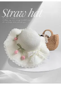 Elegant white lace straw sun hat featuring pink tulips and a delicate bow detail