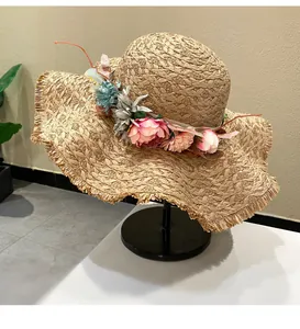 Hand-woven raffia straw sun hat with colorful flower garland and frayed brim for summer