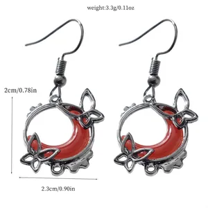 Detail view showing dimensions of blood moon crescent earrings with butterflies.