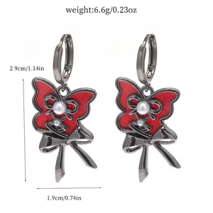 Red butterfly hoop earrings with pearl accents and bow detail including measurements