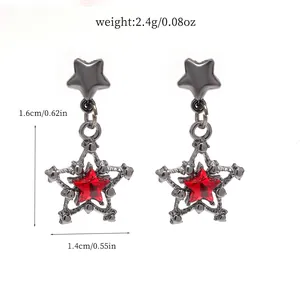 Detailed macro shot of gothic star earrings with red crystal and exact product dimensions