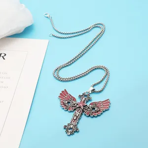 Detail showing the red enamel angel wings cross pendant necklace with star motif.