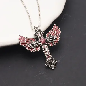 Macro detail of gothic cross necklace with angel wings and pentagram star pendant