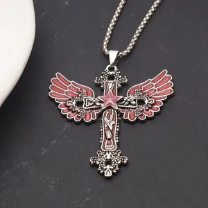 Close-up of gothic cross pendant with red angel wings and central pentagram detail.