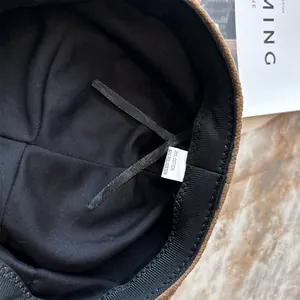 Detailed interior view of women retro beret hat showing lining and material care label