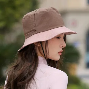 Side view of a two-tone pink and brown sun protection bucket hat for women