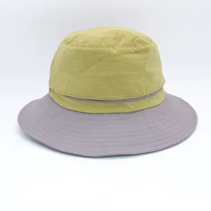 Fashionable two-tone bucket hat with olive green crown and purple brim for sun protection
