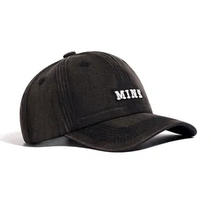 Detail view of washed cotton baseball cap with white MINI letter embroidery texture