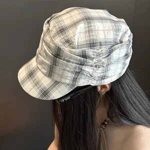 Close-up detail of a vintage plaid pleated newsboy hat for women's summer fashion