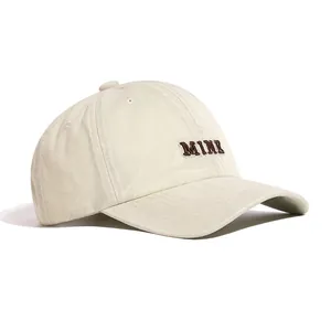 Detail side view of minimalist beige washed cotton baseball cap with MINE embroidery