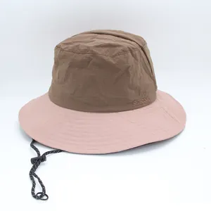 Detail of color-block outdoor bucket hat with adjustable drawstring and pink wide brim