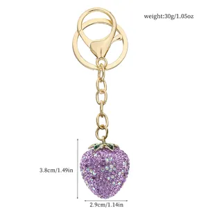 Detailed view of purple rhinestone strawberry keychain with size and weight info