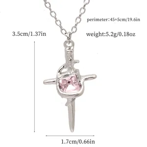 Detailed view of silver cross pendant necklace with pink gem and size specifications