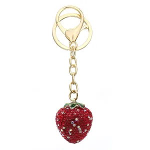 Close-up of rhinestone strawberry keychain with gold lobster clasp and key ring