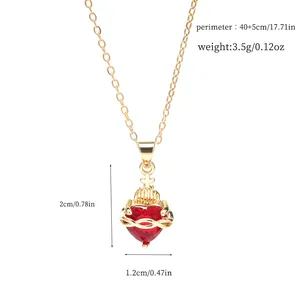 Detailed view of a gold-plated copper necklace with a red heart and cross pendant.
