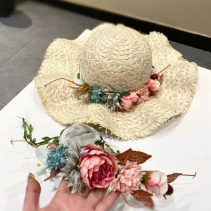 Handmade woven raffia straw sun hat with bohemian floral garland for summer beach