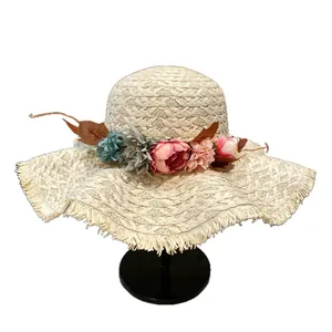 Handmade straw sun hat with wide brim and colorful floral wreath for summer beach trips