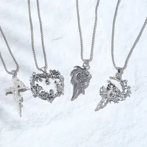 Detailed view of gothic silver necklaces with heart, moon, and vine pendants