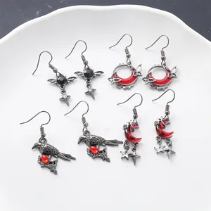 Intricate gothic earring collection with blood moon, crow, and butterfly pendant details