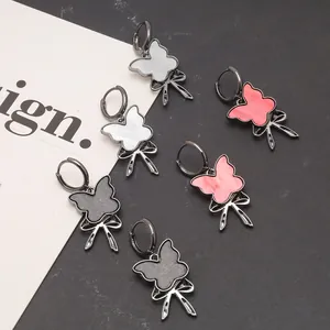 Cool style dark butterfly hoop earrings with bow pendants in grey, white, and pink