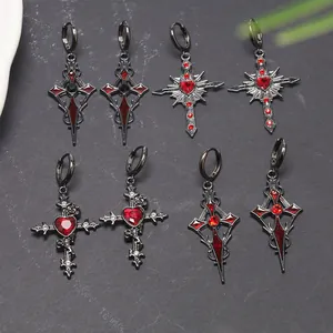 Detailed look at gothic cross earrings featuring red heart gems and black metal finish