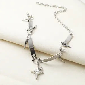 Macro view of a punk style stainless steel necklace with star and spike charms