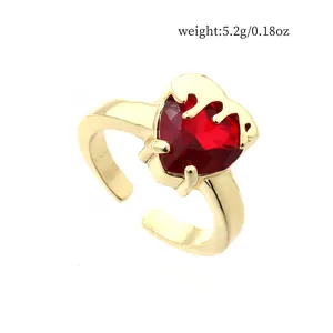 Detailed view of crown heart red zircon open ring in gold plated finish for women.