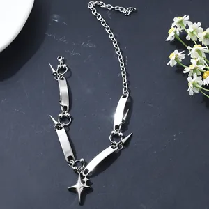 Close-up of punk stainless steel necklace featuring star charms and rivet details on black base