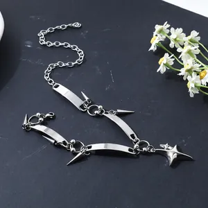 Detailed view of the punk stainless steel star and rivet necklace on a dark surface