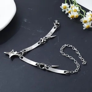 Detailed view of punk stainless steel star and spike necklace on dark surface