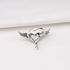 Detailed view of punk style heart ring with wings and oxidized silver finish