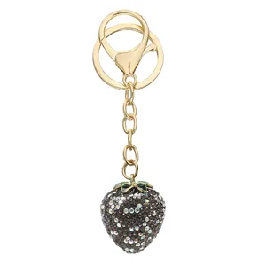 Detail showing the sparkling rhinestone pavé on the strawberry keychain.
