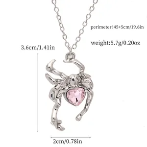 Silver spider pendant necklace featuring pink heart crystal with dimension details