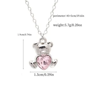 Close-up detail showing exact dimensions of cute silver bear necklace with pink heart gem