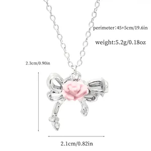 Macro detail of sweet pink rose bow pendant necklace with dimension annotations