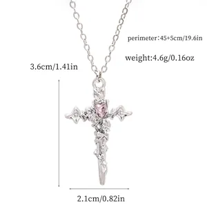 Macro view showing dimensions of silver cross pendant necklace with a pink heart