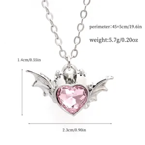 Detailed macro view of pink heart crystal necklace with bat wings and specifications