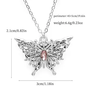 Detailed view of butterfly pendant with pink crystal and silver alloy chain.