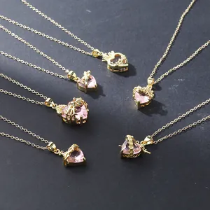 Detailed view of luxury pink heart pendant necklaces with crown and thorn designs.