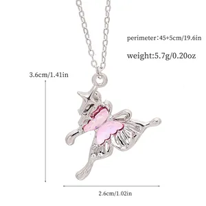 Detailed macro view of a silver butterfly necklace with pink crystal and size data.