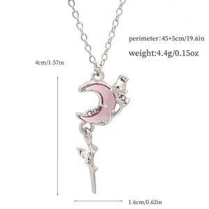 Close-up view of a pink crescent moon necklace with size and weight specifications