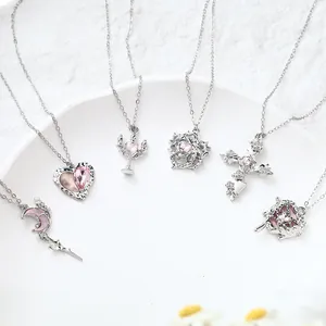 Six various silver necklaces featuring pink crystal heart, moon, and cross pendants