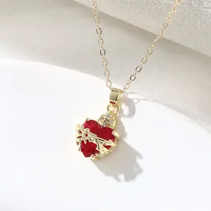 Detailed view of the gold-plated crown red heart pendant with a thorn rose design